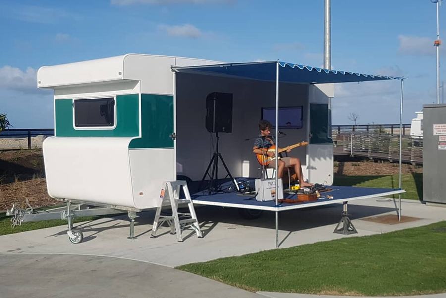 Green and white catering caravan with the servery side open